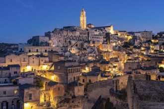 City view of Matera with the Sassi cave settlements and the cathedral at dusk, Matera, Basilicata,
