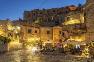 Restaurants in Sasso Barisano at dusk, Matera, Basilicata, Italy