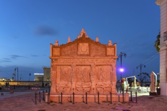 The colourfully illuminated Greek fountain Fontana Greca at dusk, Gallipoli, Apulia, Italy