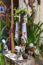 Religious syncretism of Umbanda and Cotolicism mixed on an altar among the plants, Belo Horizonte,