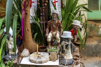 Umbanda and Christianity mixed on an altar among plants with deities and religious objects