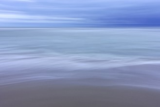 Sandy beach beach, sea and sky, ICM (Intentional Camera Movement), blurred. The Netherlands