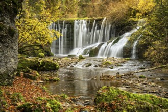 The Gerats waterfall in autumn. Moss-covered rocks and trees in autumn leaves. Gerats, Oberallgäu,