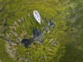 Top Down over boat and mud from drone, Paulsgrove Lake, Portchester Castle, Portchester, Fareham,