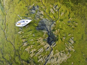 Top Down over boat and mud from drone, Paulsgrove Lake, Portchester Castle, Portchester, Fareham,