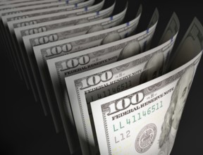 Spot lit abstract close-up angle of U.S. 100 dollar bills isolated on a black background