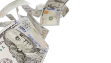 Randomly falling U.S. 100 dollar bills isolated on a white background