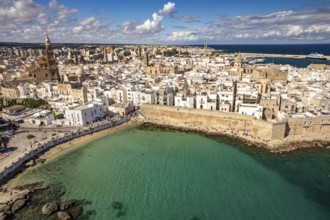 Old town of Monopoli with the cathedral, city walls and Cala Porta Vecchia beach seen from above,