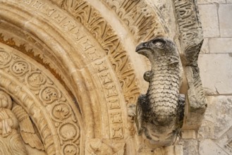 Bird's head above the portal of the church of Santa Maria Maggiore in Monte Sant'Angelo, Gargano,