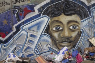 Painting created at the Berlin Wall in the 1990s, rubbish in front of the Wall, Berlin, Germany