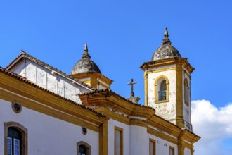 Tower and crucifix of a historic baroque church in the city of Ouro Preto in Minas Gerais, Ouro
