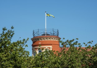 Swedish flag on a tower and at blue sky in Ystad, Skåne county, Sweden, Scandinavie