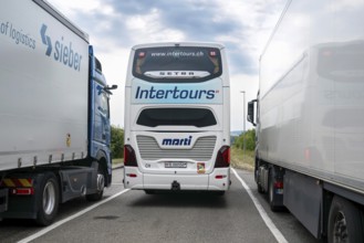 Rest area Bern-Fribourg coach between two lorries, Schmitten, Switzerland