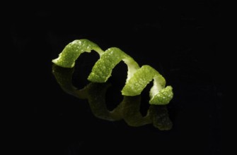 Lime zest against a black background
