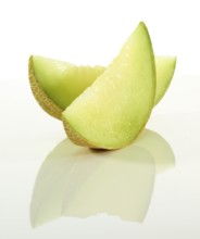 Honeydew melon, 2 melon slices in front of a white background