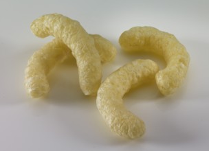 Corn flips, puffed corn snack in front of a white background