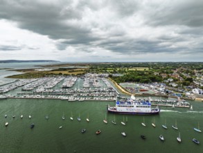 Wight Light car ferry to Isle of Wight on Lymington River and marina from drone, Lymington, New