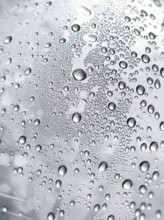 Drops of water on plastic bottle, neutrally illuminated, detailed view