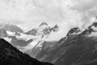 Four-thousand metre mountains and glaciers in clouds, black and white photograph, above Zinal, Val