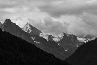 The Besso mountains with twin peaks and the Obergabelhorn, black and white photograph, view from