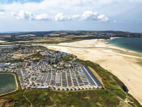 Holiday homes over Hayle Beach and Hayle Estuary from drone, St Ives Bay, Cornwall, England, United