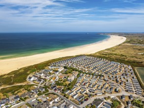 Holiday homes over Hayle Beach and Hayle Estuary from drone, St Ives Bay, Cornwall, England, United