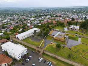Historic walls and buildings with neighbouring trees in an urban environment, aerial view, bank