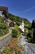 View of the village with the Roman Catholic Church of St Idda, Lake Lucerne, Bauen, Canton, Uri,