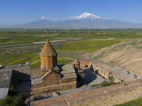 Historical monastery with Mount Ararat in the background and surrounding landscape, aerial view,
