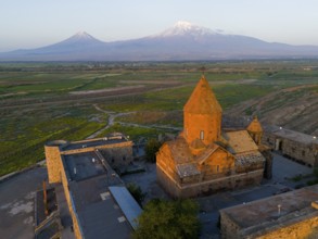 Historical monastery in the morning light with Mount Ararat in the background, aerial view,