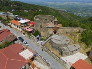Historic castle with surrounding traditional buildings on a hill, aerial view, Sighnaghi, Signagi,