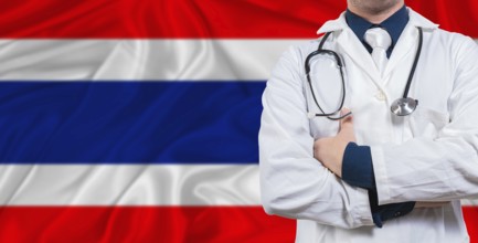 Male doctor with stethoscope on Thai flag. Doctor holding stethoscope on Thailand flag