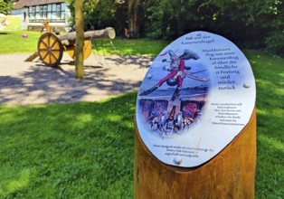 Sign of Munchausen's ride on the cannonball on the children's playground in the Munchausen town of