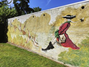 Painting on a wall Münchhausen on a duck hunt in the Münchhausen town of Bodenwerder,