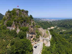 Panorama of a rocky hill with flag and wide valley view, aerial view, Ünye Castle, Ünye Kalesi,