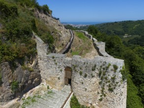 Old castle ruins amidst lush vegetation and under a clear sky, aerial view, Ünye Castle, Ünye