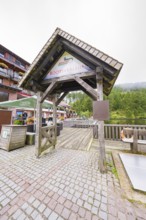 Wooden roofing at a boat hire with people and surrounding buildings, Mummelsee, Seebach, Ortenau