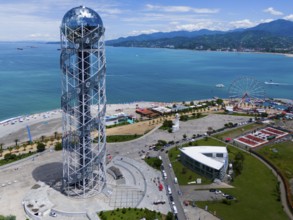Steel construction tower overlooking the sea, Ferris wheel and surrounding coastline on a sunny