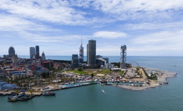 Panorama of a modern city by the sea with striking buildings and an unobstructed view of the water,