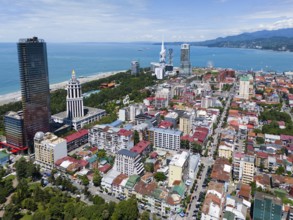 City view with skyscrapers and sea in the background, blue sky and lively atmosphere, aerial view,