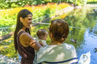 Three generations of a latin family, grandmother, mother, and baby granddaughter, spending quality