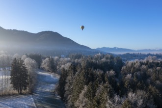 Hot air balloon in winter over Bad Heilbrunn, Upper Bavaria, Bavaria, Germany