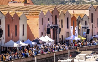Sardinia, residential buildings on the promenade, guests at the restaurants with outdoor dining,