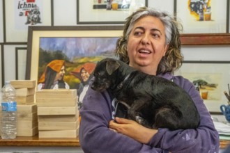 Sardinia, Pina Monne, woman portrait and dog on arm, artist, Tinnura, Europe, Oristano province,