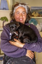 Sardinia, Pina Monne, woman portrait and dog on arm, artist, Tinnura, Europe, Oristano province,