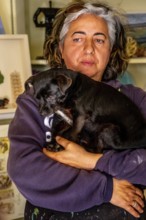 Sardinia, Pina Monne, portrait of woman and dog on arm, artist, Tinnura, Europe, Oristano province,