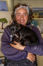 Sardinia, Pina Monne, female portrait and dog on arm, artist, Tinnura, Europe, Oristano province,