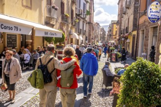 Sardinia, tourists in a pedestrian zone, stroll of tourists on a shopping street, Bosa, Europe,