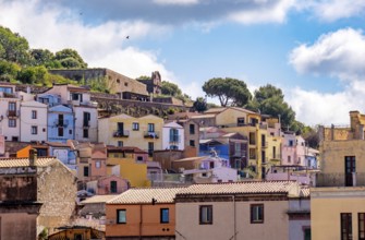 Sardinia, picturesque view of Bosa with pavilions on the promenade, residential buildings and