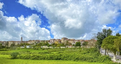 Sardinia, town view, town wall and church tower of Thiesi, blue sky with clouds, Thiesi, Europe,